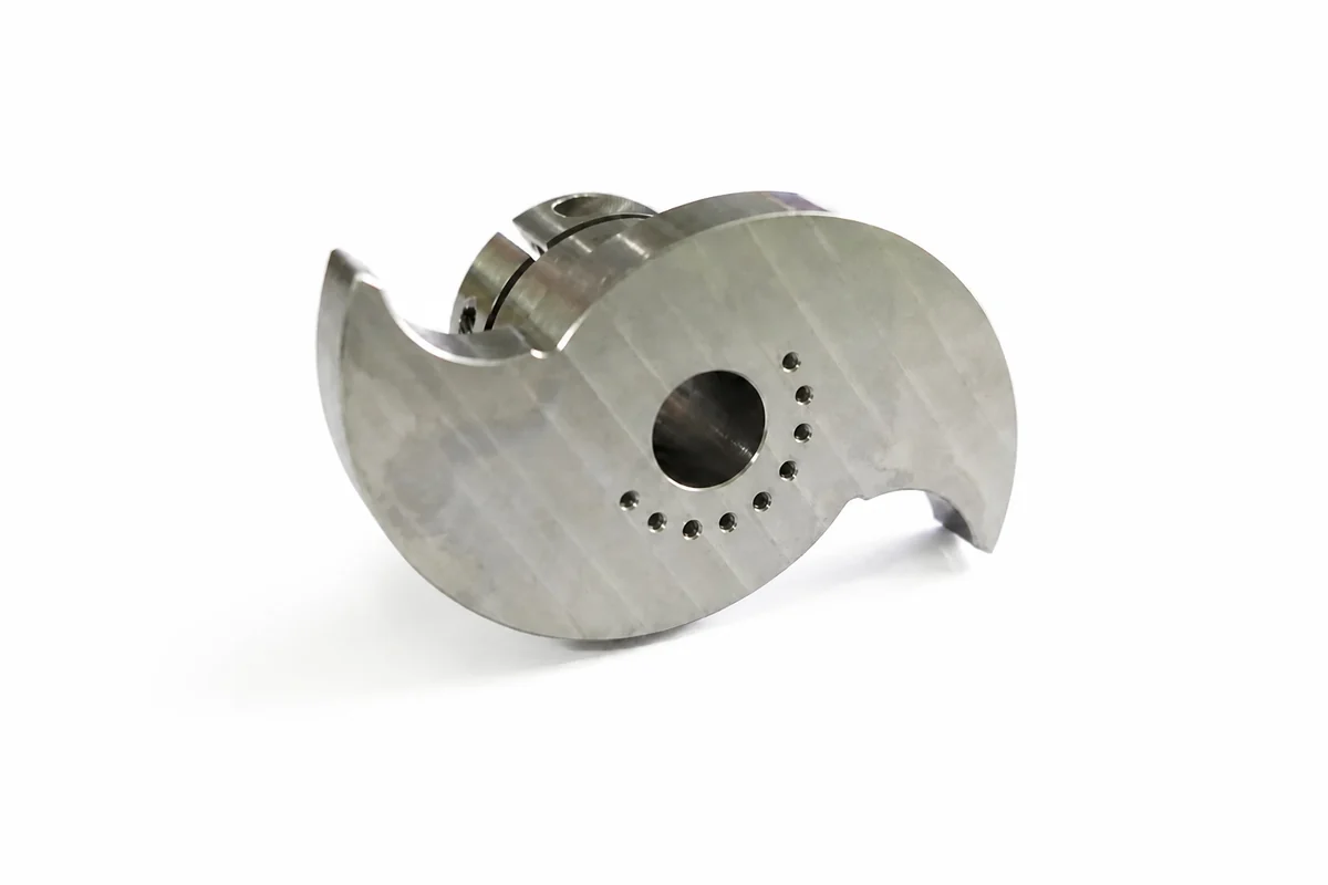 Precision-machined metal component with a curved profile and drilled holes.