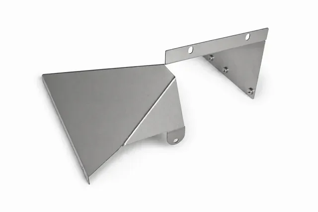 Formed sheet metal components on a neutral background.